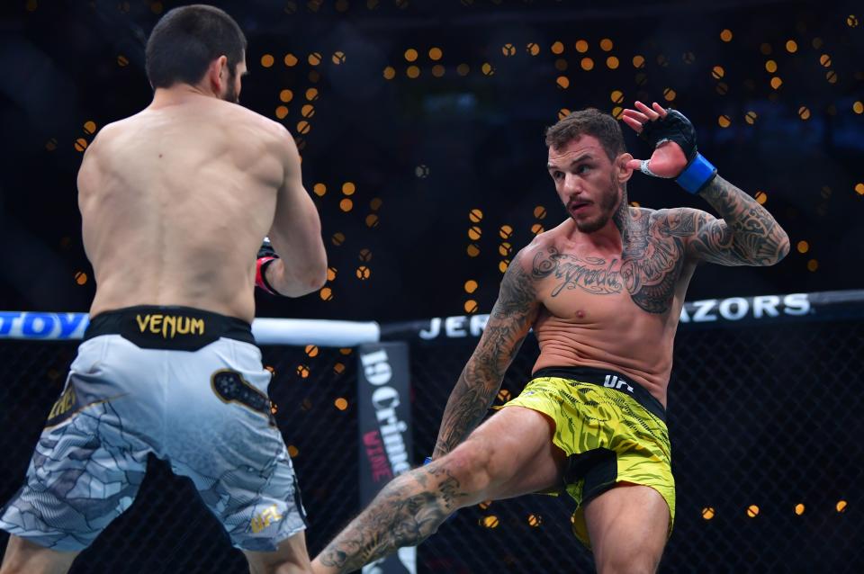 Jan 18, 2025; Inglewood, California, USA; Islam Makhachev (red gloves) fights Renato Moicano (blue gloves) in a lightweight title fight during UFC 311 at Intuit Dome. Mandatory Credit: Gary A. Vasquez-Imagn Images