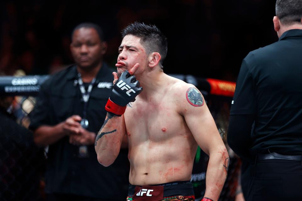 Nov 2, 2024; Edmonton, Alberta, Canada; Brandon Moreno (red gloves) celebrates after defeating Amir Albazi (not pictured) in a flyweight bout during UFC Fight Night at Rogers Place. Mandatory Credit: Perry Nelson-Imagn Images