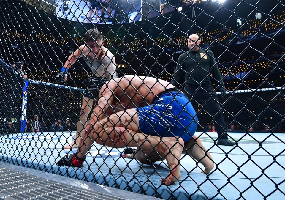 Jan 18, 2025; Inglewood, California, USA; Ricky Turcios (red gloves) fights Benardo Sopaj (blue gloves) during UFC 311 at Intuit Dome. Mandatory Credit: Gary A. Vasquez-Imagn Images