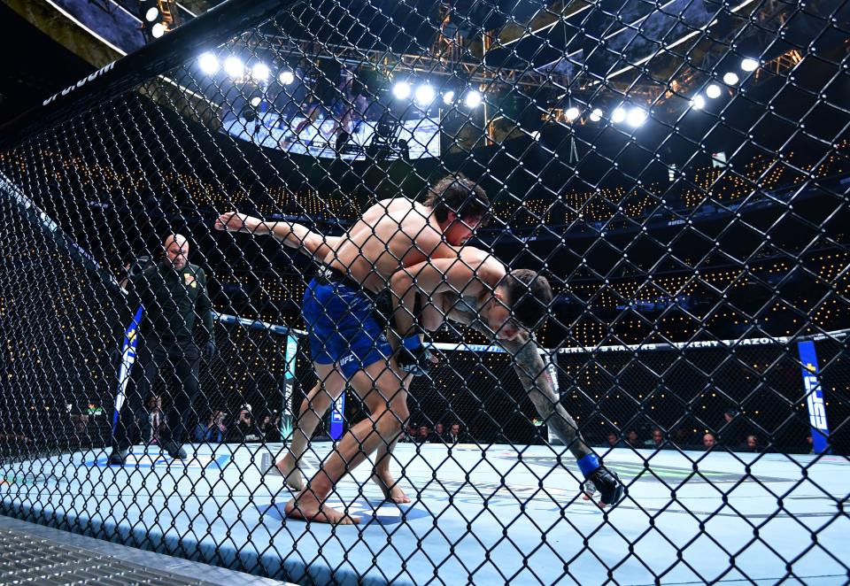 Jan 18, 2025; Inglewood, California, USA; Ricky Turcios (red gloves) fights Benardo Sopaj (blue gloves) during UFC 311 at Intuit Dome. Mandatory Credit: Gary A. Vasquez-Imagn Images