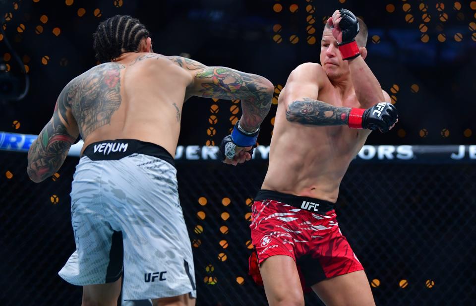 Jan 18, 2025; Inglewood, California, USA; Grant Dawson (red gloves) fights Diego Ferreira (blue gloves) during UFC 311 at Intuit Dome. Mandatory Credit: Gary A. Vasquez-Imagn Images