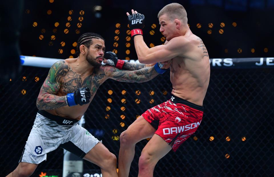 Jan 18, 2025; Inglewood, California, USA; Grant Dawson (red gloves) fights Diego Ferreira (blue gloves) during UFC 311 at Intuit Dome. Mandatory Credit: Gary A. Vasquez-Imagn Images