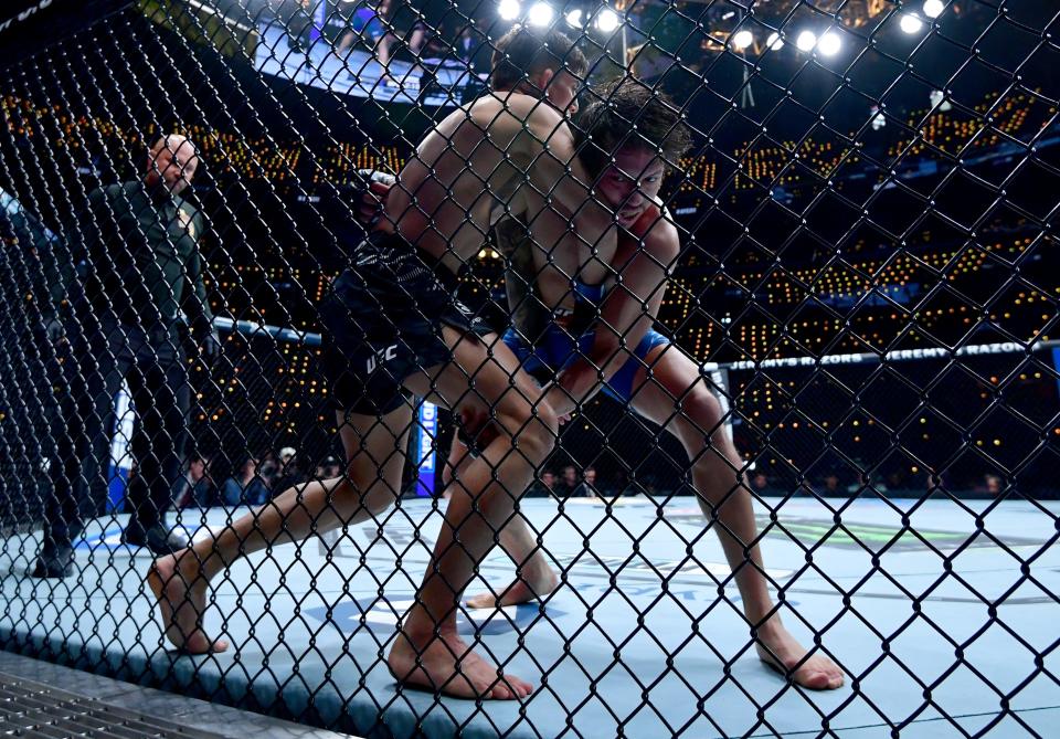 Jan 18, 2025; Inglewood, California, USA; Ricky Turcios (red gloves) fights Benardo Sopaj (blue gloves) during UFC 311 at Intuit Dome. Mandatory Credit: Gary A. Vasquez-Imagn Images