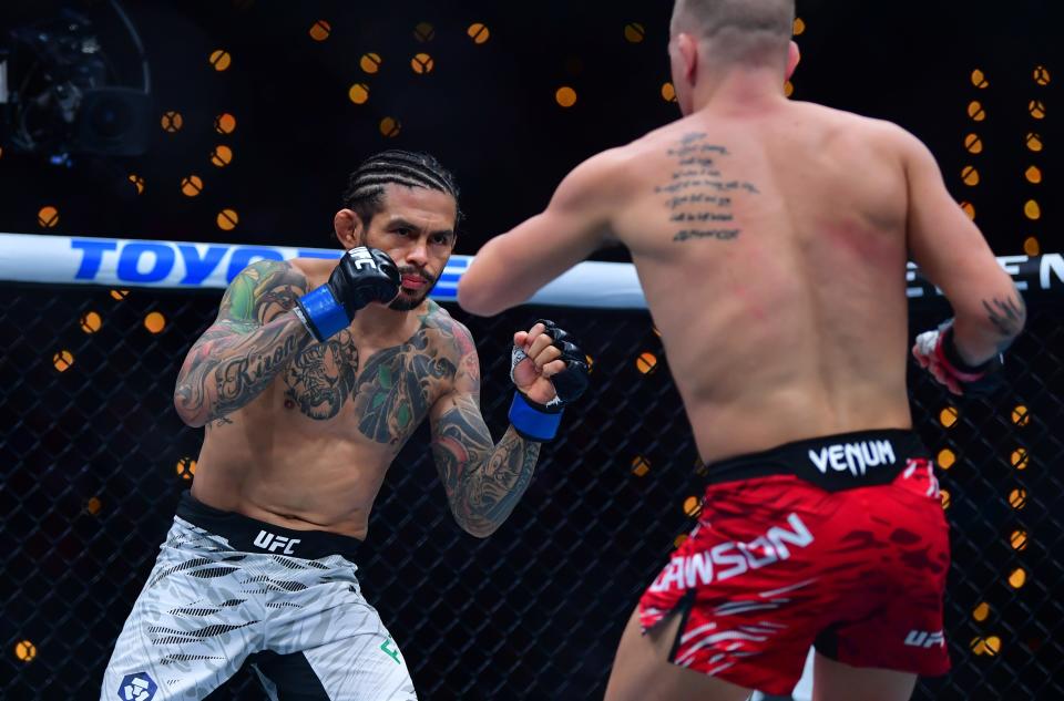 Jan 18, 2025; Inglewood, California, USA; Grant Dawson (red gloves) fights Diego Ferreira (blue gloves) during UFC 311 at Intuit Dome. Mandatory Credit: Gary A. Vasquez-Imagn Images