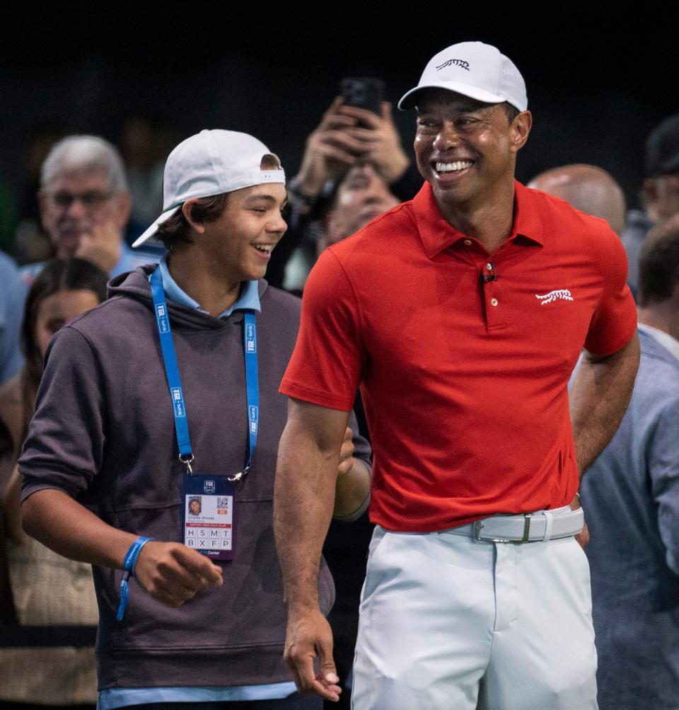 Charlie and Tiger Woods smile during warm ups at SoFi Center during golf match between Jupiter Links and Los Angeles Golf Club in the TGL, interactive golf league founded by Tiger Woods and Rory McIlroy on January 14, 2025 in Palm Beach Gardens, Florida.