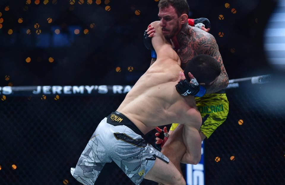 Jan 18, 2025; Inglewood, California, USA; Islam Makhachev (red gloves) fights Renato Moicano (blue gloves) in a lightweight title fight during UFC 311 at Intuit Dome. Mandatory Credit: Gary A. Vasquez-Imagn Images