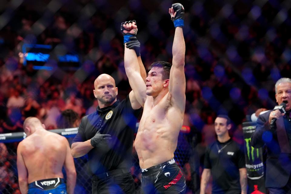 Oct 5, 2024; Salt Lake City, Utah, USA; Alexander Hernandez (blue gloves) reacts after defeating Austin Hubbard (blue gloves) during UFC 307 at Delta Center. Mandatory Credit: Stephen R. Sylvanie-Imagn Images