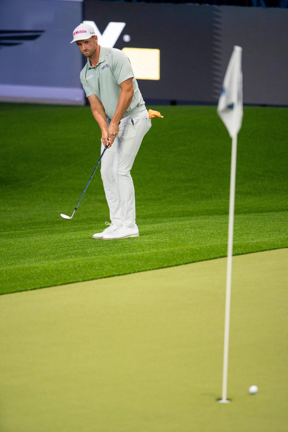 Golfer Wyndham Clark watches his chip shot roll on the green during the inaugural golf match at SoFi Center, the home of TGL, the interactive golf league founded by Tiger Woods and Rory McIlroy on January 7, 2025 in Palm Beach Gardens, Florida.