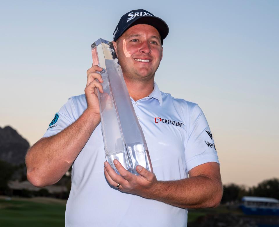 Sepp Straka poses with his trophy on the 18th green of the Pete Dye Stadium Course after winning The American Express at PGA West in La Quinta, Calif., Sunday, Jan. 19, 2025.