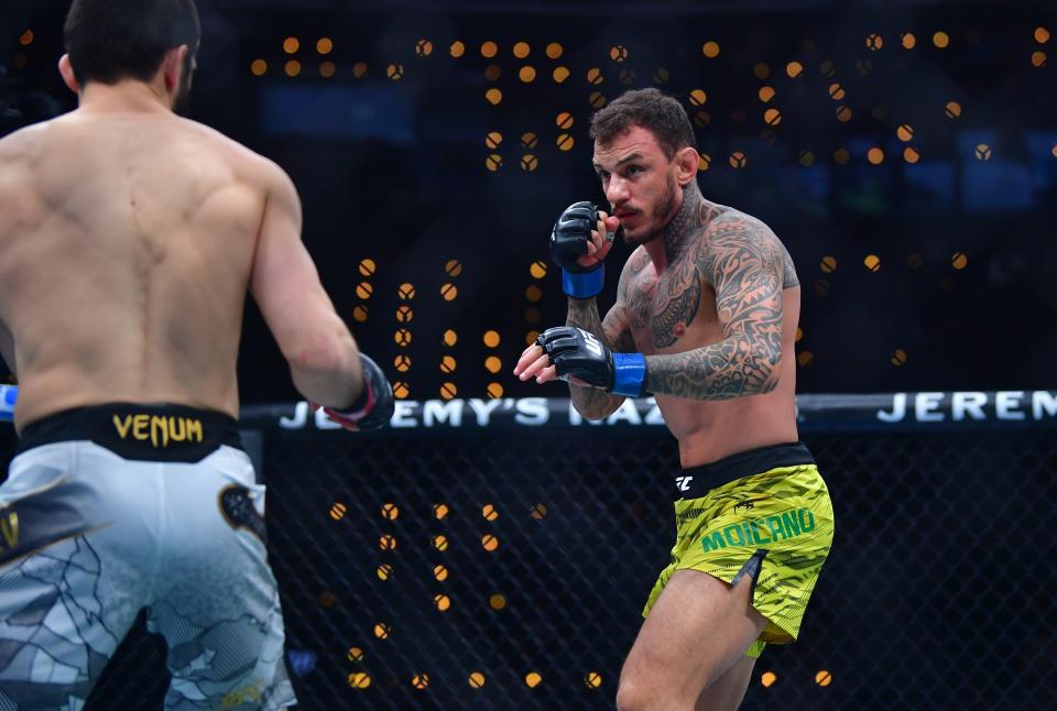 Jan 18, 2025; Inglewood, California, USA; Islam Makhachev (red gloves) fights Renato Moicano (blue gloves) in a lightweight title fight during UFC 311 at Intuit Dome. Mandatory Credit: Gary A. Vasquez-Imagn Images