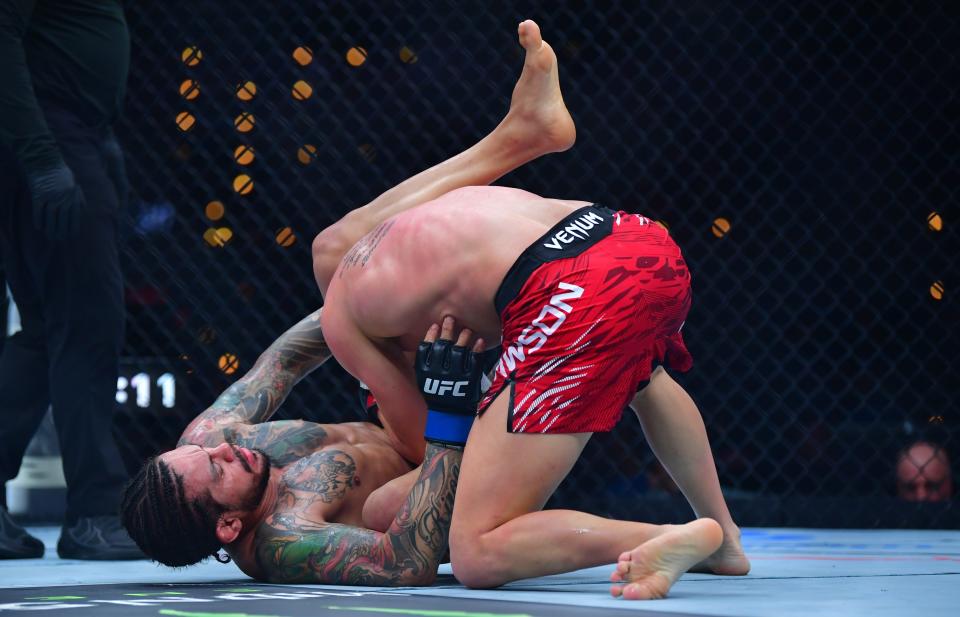 Jan 18, 2025; Inglewood, California, USA; Grant Dawson (red gloves) fights Diego Ferreira (blue gloves) during UFC 311 at Intuit Dome. Mandatory Credit: Gary A. Vasquez-Imagn Images