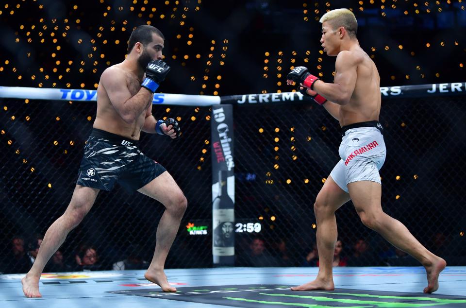 Jan 18, 2025; Inglewood, California, USA; Rinya Nakamura (red gloves) fights Muin Gafurov (blue gloves) during UFC 311 at Intuit Dome. Mandatory Credit: Gary A. Vasquez-Imagn Images