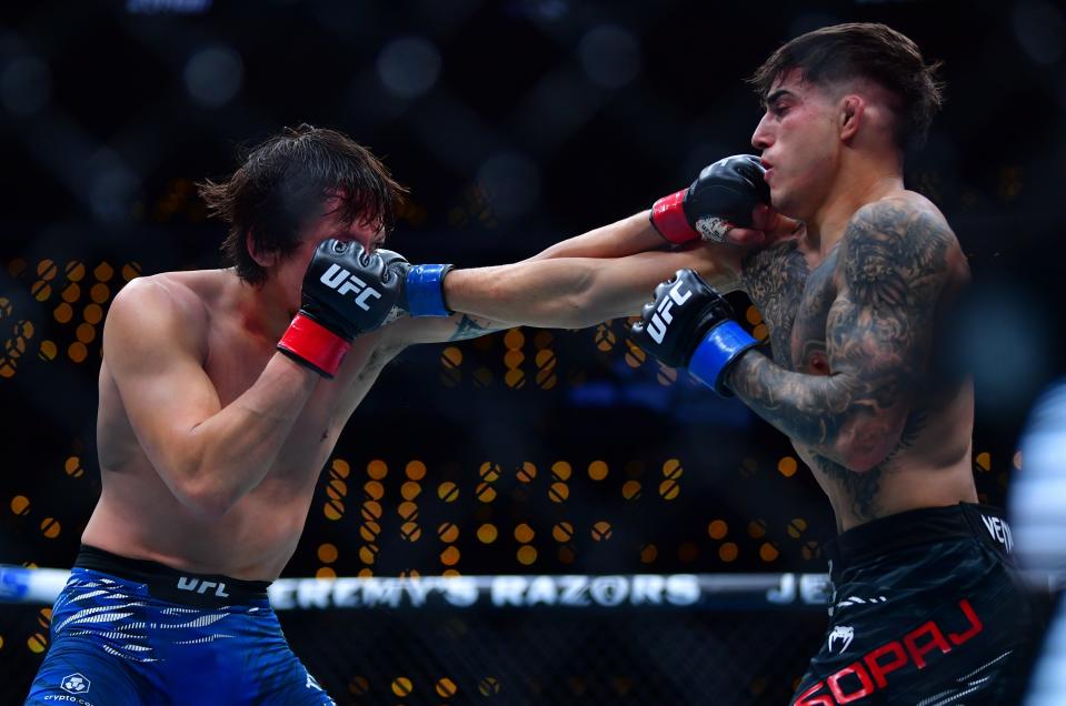 Jan 18, 2025; Inglewood, California, USA; Ricky Turcios (red gloves) fights Benardo Sopaj (blue gloves) during UFC 311 at Intuit Dome. Mandatory Credit: Gary A. Vasquez-Imagn Images