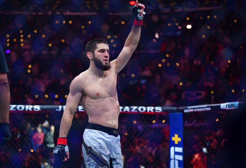 Jan 18, 2025; Inglewood, California, USA; Islam Makhachev (red gloves) reacts after defeating Renato Moicano (blue gloves) in a lightweight title fight during UFC 311 at Intuit Dome. Mandatory Credit: Gary A. Vasquez-Imagn Images