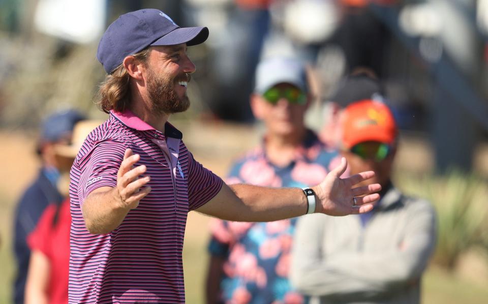 Tommy Fleetwood celebrates after holing the winning putt to earn victory for Great Britain & Ireland at Abu Dhabi Golf Resort on January 12