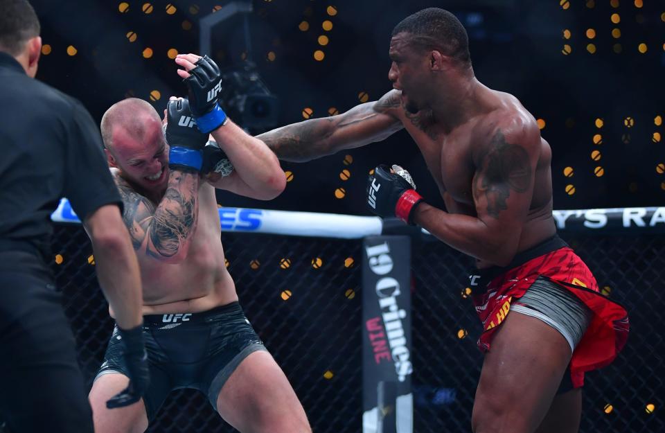 Jan 18, 2025; Inglewood, California, USA; Jailton Almeida (red gloves) fights Serghei Spivac (blue gloves) during UFC 311 at Intuit Dome. Mandatory Credit: Gary A. Vasquez-Imagn Images