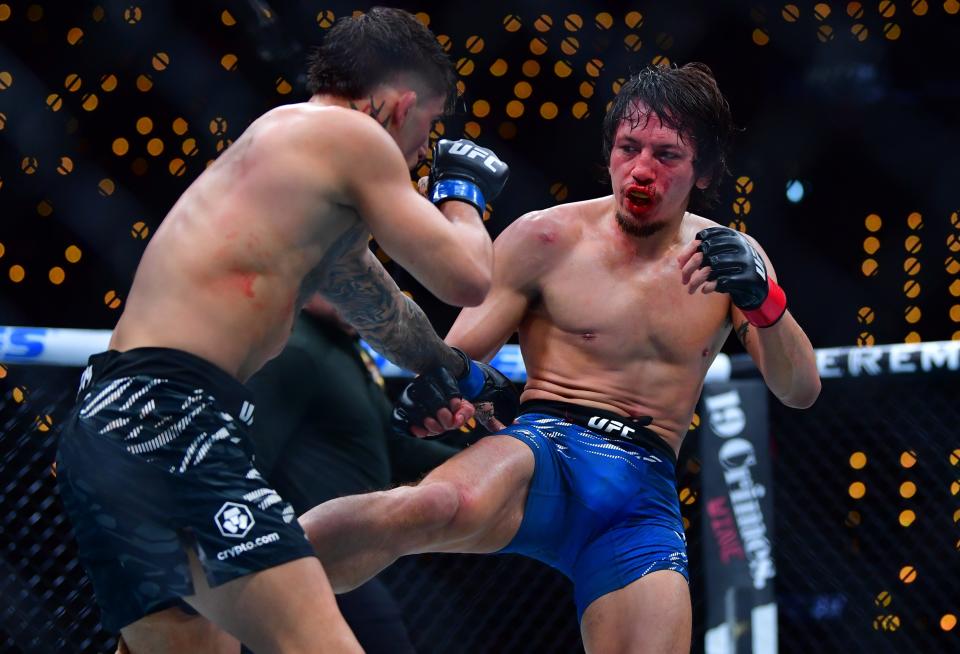 Jan 18, 2025; Inglewood, California, USA; Ricky Turcios (red gloves) fights Benardo Sopaj (blue gloves) during UFC 311 at Intuit Dome. Mandatory Credit: Gary A. Vasquez-Imagn Images