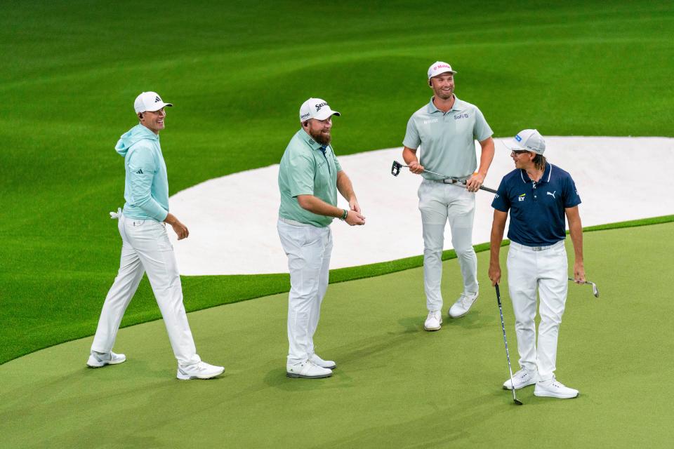 Bay Club golfers, Ludvig Aberg, left, Shane Lowry and Wyndham Clark laugh after New York Golf Club's Rickie Fowler putted during the inaugural match at SoFi Center, the home of TGL, the interactive golf league founded by Tiger Woods and Rory McIlroy on January 7, 2025 in Palm Beach Gardens, Florida.