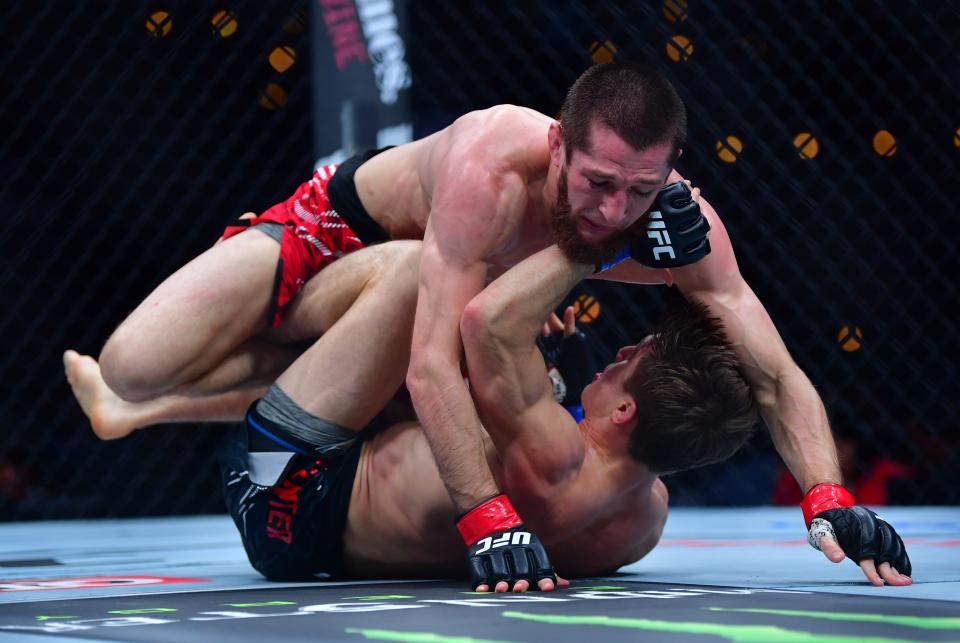 Jan 18, 2025; Inglewood, California, USA; Tagir Ulanbekov (red gloves) fights Clayton Carpenter (blue gloves) during UFC 311 at Intuit Dome. Mandatory Credit: Gary A. Vasquez-Imagn Images