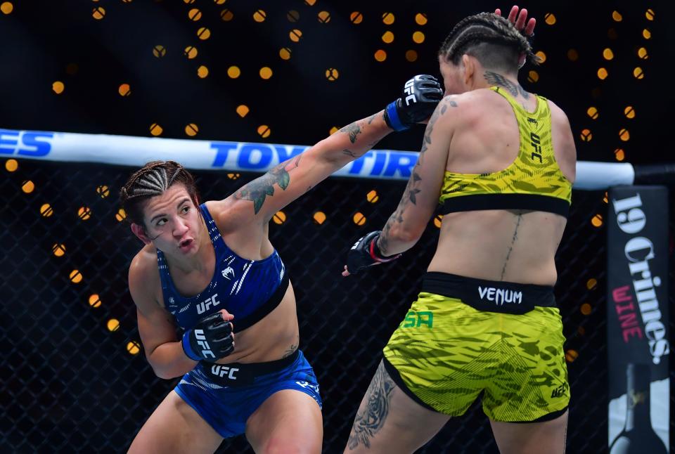 Jan 18, 2025; Inglewood, California, USA; Karol Rosa (red gloves) fights Ailin Perez (blue gloves) during UFC 311 at Intuit Dome. Mandatory Credit: Gary A. Vasquez-Imagn Images