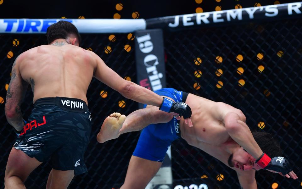 Jan 18, 2025; Inglewood, California, USA; Ricky Turcios (red gloves) fights Benardo Sopaj (blue gloves) during UFC 311 at Intuit Dome. Mandatory Credit: Gary A. Vasquez-Imagn Images