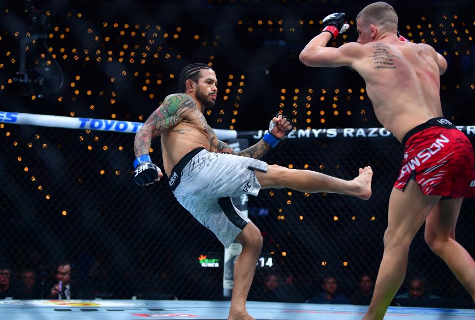 Jan 18, 2025; Inglewood, California, USA; Grant Dawson (red gloves) fights Diego Ferreira (blue gloves) during UFC 311 at Intuit Dome. Mandatory Credit: Gary A. Vasquez-Imagn Images