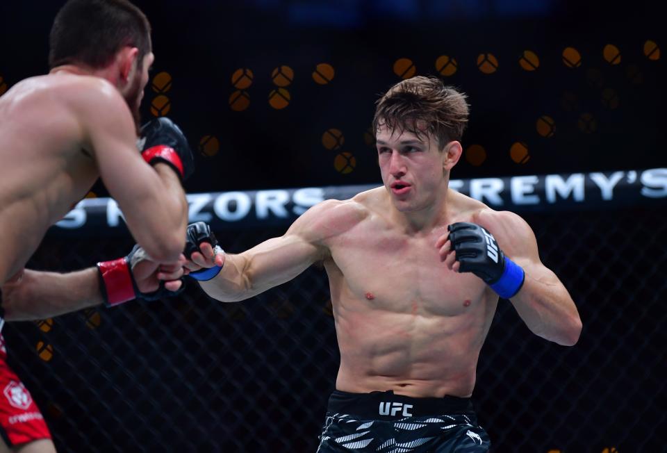 Jan 18, 2025; Inglewood, California, USA; Tagir Ulanbekov (red gloves) fights Clayton Carpenter (blue gloves) during UFC 311 at Intuit Dome. Mandatory Credit: Gary A. Vasquez-Imagn Images