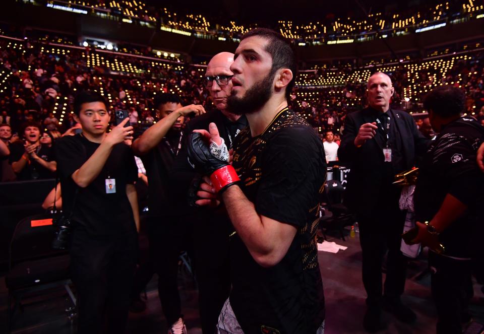 Jan 18, 2025; Inglewood, California, USA; Islam Makhachev (red gloves) leaves the octagon after defeating Renato Moicano (not pictured) in a lightweight title fight during UFC 311 at Intuit Dome. Mandatory Credit: Gary A. Vasquez-Imagn Images