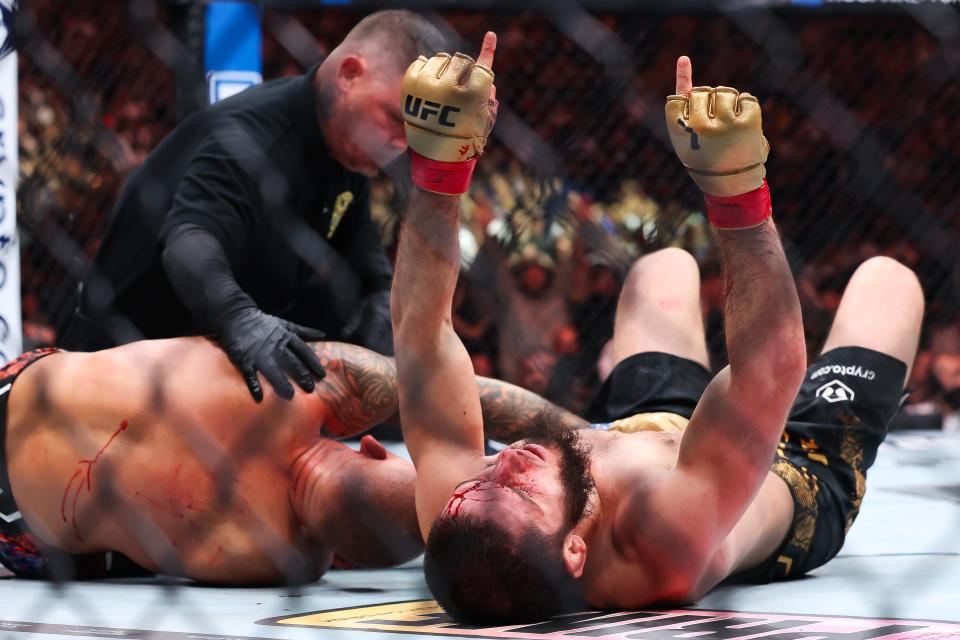 Islam Makhachev (right) celebrates after submitting Dustin Poirier at UFC 302 (Getty Images)