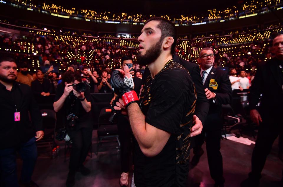 Jan 18, 2025; Inglewood, California, USA; Islam Makhachev (red gloves) leaves the octagon after defeating Renato Moicano (not pictured) in a lightweight title fight during UFC 311 at Intuit Dome. Mandatory Credit: Gary A. Vasquez-Imagn Images