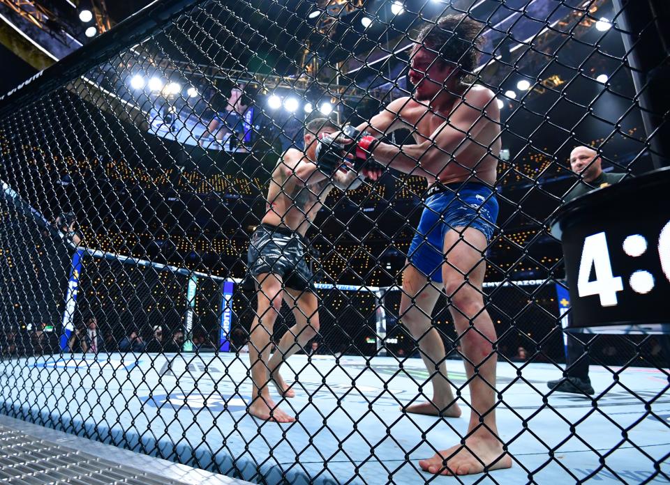 Jan 18, 2025; Inglewood, California, USA; Ricky Turcios (red gloves) fights Benardo Sopaj (blue gloves) during UFC 311 at Intuit Dome. Mandatory Credit: Gary A. Vasquez-Imagn Images