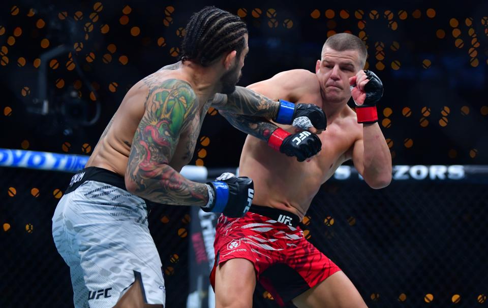 Jan 18, 2025; Inglewood, California, USA; Grant Dawson (red gloves) fights Diego Ferreira (blue gloves) during UFC 311 at Intuit Dome. Mandatory Credit: Gary A. Vasquez-Imagn Images