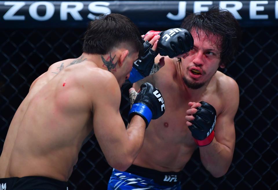 Jan 18, 2025; Inglewood, California, USA; Ricky Turcios (red gloves) fights Benardo Sopaj (blue gloves) during UFC 311 at Intuit Dome. Mandatory Credit: Gary A. Vasquez-Imagn Images