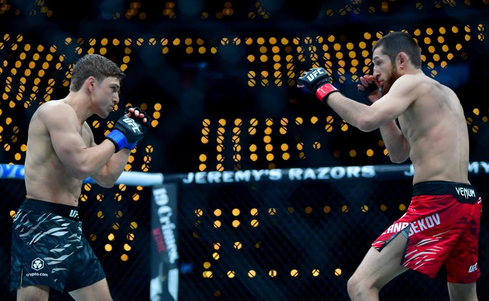 Jan 18, 2025; Inglewood, California, USA; Tagir Ulanbekov (red gloves) fights Clayton Carpenter (blue gloves) during UFC 311 at Intuit Dome. Mandatory Credit: Gary A. Vasquez-Imagn Images