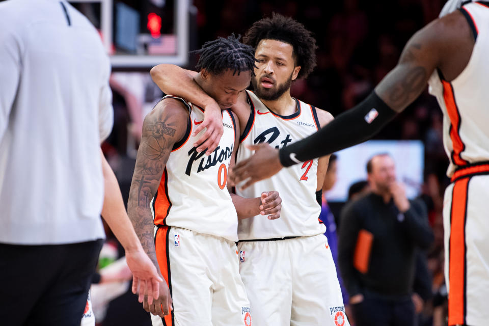 PHOENIX, ARIZONA - DECEMBER 21: Cade Cunningham #2 of the Detroit Pistons hugs Ronald Holland II #00 during the second half of the NBA game against the Phoenix Suns at Footprint Center on December 21, 2024 in Phoenix, Arizona. The Pistons defeated the Suns 133-125. NOTE TO USER: User expressly acknowledges and agrees that, by downloading and or using this photograph, User is consenting to the terms and conditions of the Getty Images License Agreement. (Photo by Kelsey Grant/Getty Images)