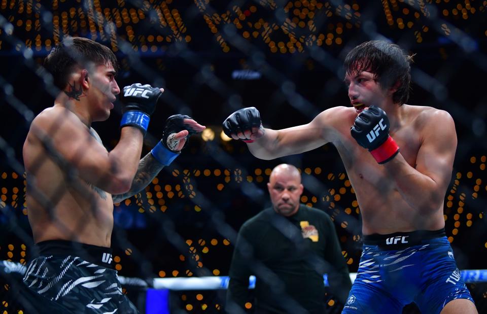 Jan 18, 2025; Inglewood, California, USA; Ricky Turcios (red gloves) fights Benardo Sopaj (blue gloves) during UFC 311 at Intuit Dome. Mandatory Credit: Gary A. Vasquez-Imagn Images