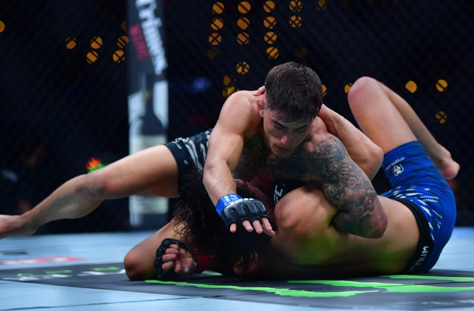 Jan 18, 2025; Inglewood, California, USA; Ricky Turcios (red gloves) fights Benardo Sopaj (blue gloves) during UFC 311 at Intuit Dome. Mandatory Credit: Gary A. Vasquez-Imagn Images