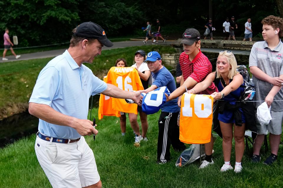 Peyton Manning signs autographs during the Workday Golden Bear Pro-Am for the Memorial Tournament at Muirfield Village Golf Club.