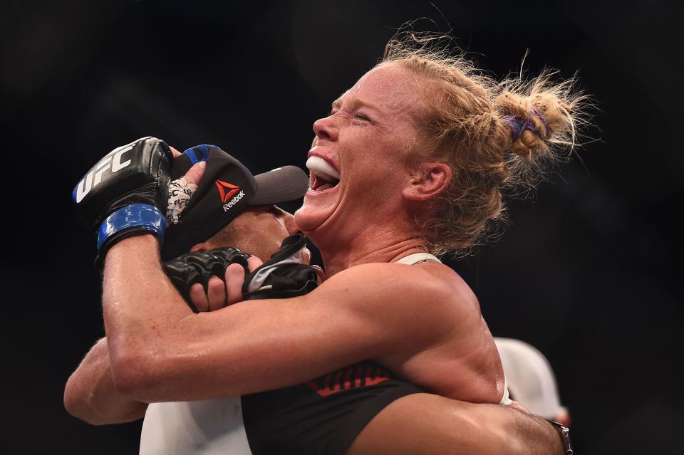 Holly Holm (blue gloves) celebrates after defeating Ronda Rousey (not pictured) during UFC 193. (USA TODAY Sports)