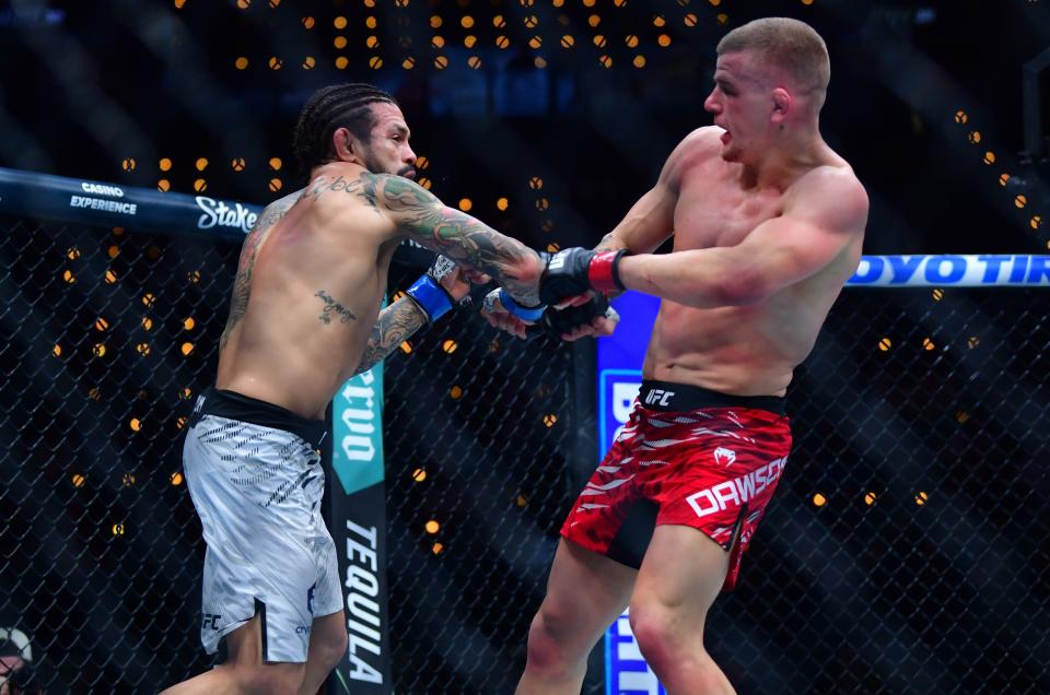 Jan 18, 2025; Inglewood, California, USA; Grant Dawson (red gloves) fights Diego Ferreira (blue gloves) during UFC 311 at Intuit Dome. Mandatory Credit: Gary A. Vasquez-Imagn Images