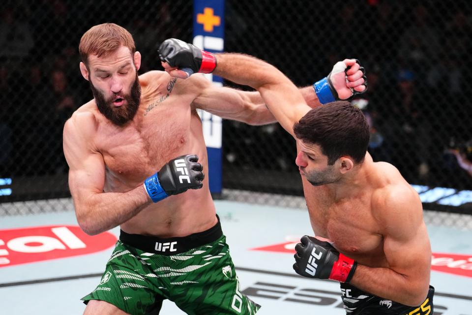 LAS VEGAS, NEVADA - JANUARY 11: (R-L) Thiago Moises of Brazil punches Trey Ogden in a welterweight fight during the UFC Fight Night event at UFC APEX on January 11, 2025 in Las Vegas, Nevada. (Photo by Chris Unger/Zuffa LLC via Getty Images)