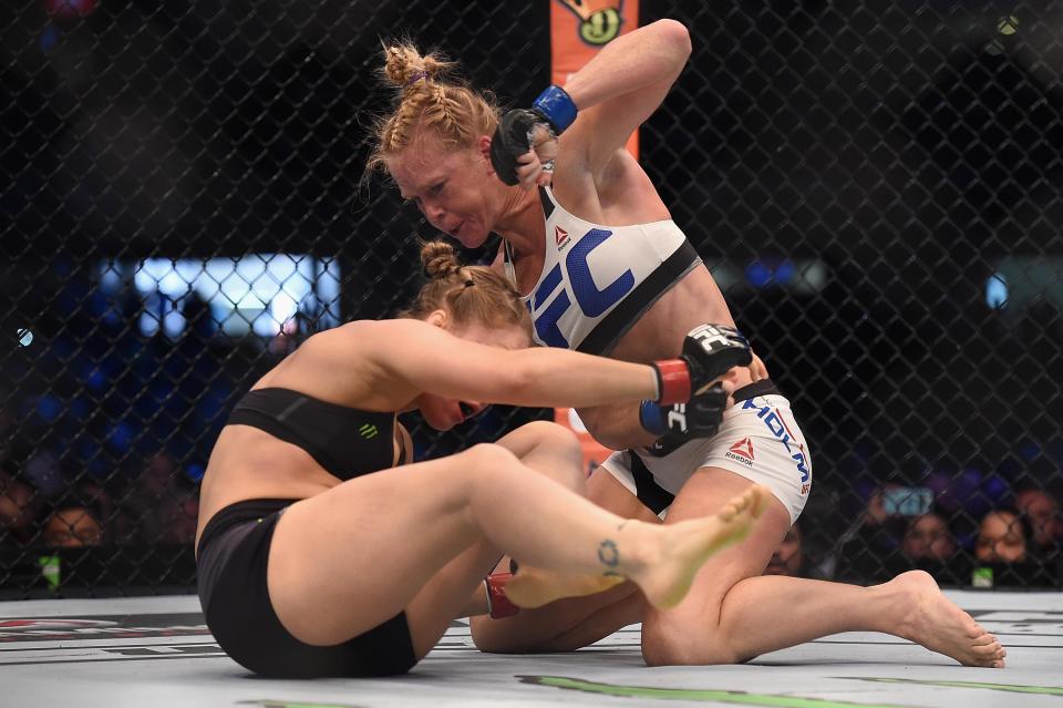 Nov 15, 2015; Melbourne, Australia; Ronda Rousey (red gloves) competes against Holly Holm (blue gloves) during UFC 193 at Etihad Stadium. Mandatory Credit: Matt Roberts-USA TODAY Sports