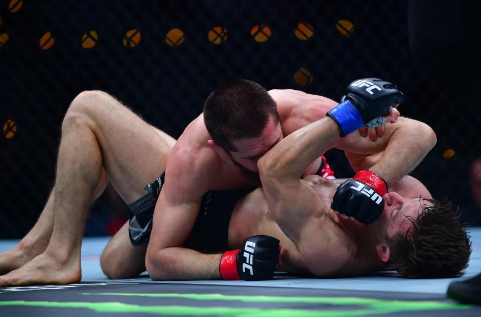 Jan 18, 2025; Inglewood, California, USA; Tagir Ulanbekov (red gloves) fights Clayton Carpenter (blue gloves) during UFC 311 at Intuit Dome. Mandatory Credit: Gary A. Vasquez-Imagn Images