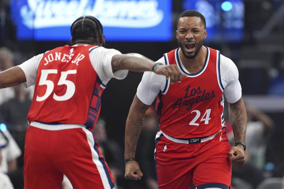 Clippers guard Norman Powell, right, celebrates with teammate Derrick Jones Jr. after making a three-point shot.