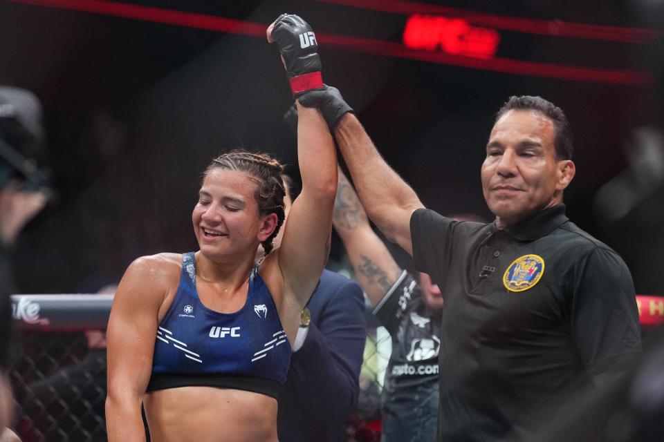 Jun 1, 2024; Newark, New Jersey, USA; Ailin Perez (red gloves) celebrates defeating Joselyne Edwards (blue gloves) during UFC 302 at Prudential Center. Mandatory Credit: Joe Camporeale-USA TODAY Sports