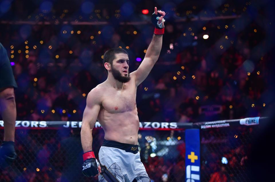 Jan 18, 2025; Inglewood, California, USA; Islam Makhachev (red gloves) reacts after defeating Renato Moicano (blue gloves) in a lightweight title fight during UFC 311 at Intuit Dome. Mandatory Credit: Gary A. Vasquez-Imagn Images