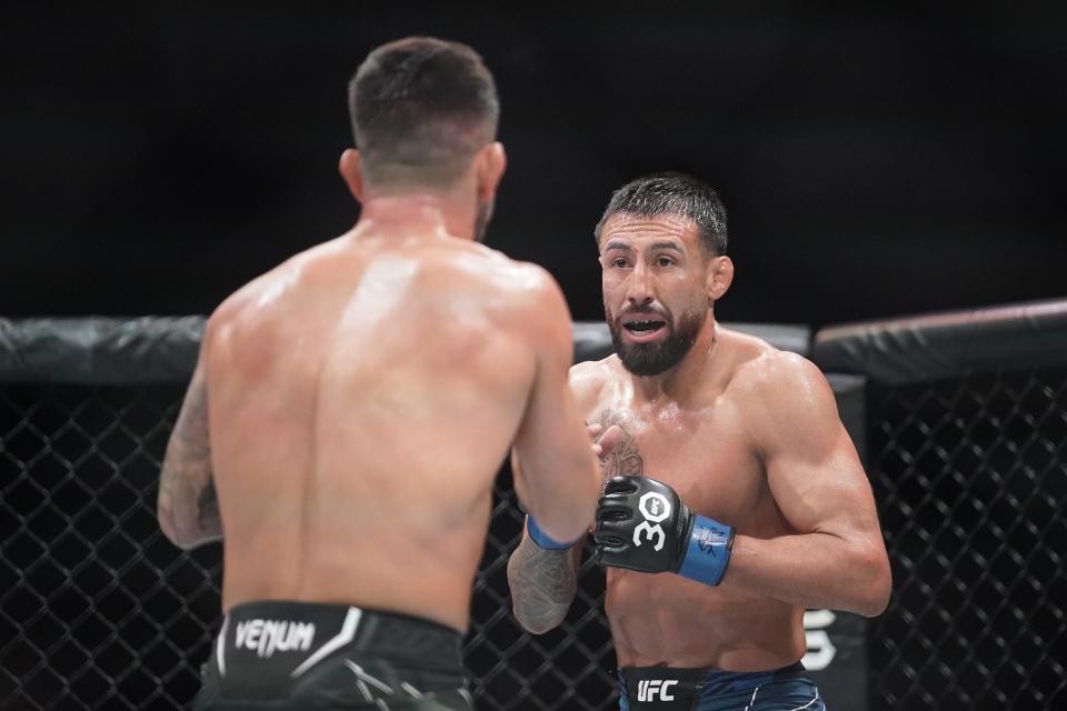 Apr 15, 2023; Kansas City, Missouri, USA; Pedro Munhoz (red gloves) fights Chris Gutierrez (blue gloves) during UFC Fight Night at T-Mobile Center. Mandatory Credit: Denny Medley-USA TODAY Sports