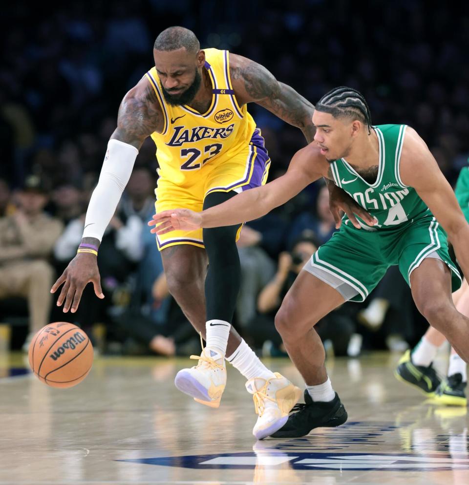 Boston's Jaden Springer, right, tries to steal the ball from Lakers star LeBron James.