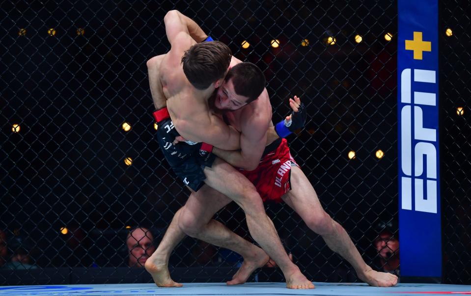 Jan 18, 2025; Inglewood, California, USA; Tagir Ulanbekov (red gloves) fights Clayton Carpenter (blue gloves) during UFC 311 at Intuit Dome. Mandatory Credit: Gary A. Vasquez-Imagn Images