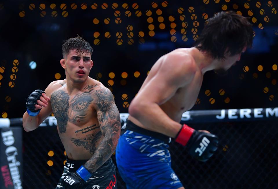 Jan 18, 2025; Inglewood, California, USA; Ricky Turcios (red gloves) fights Benardo Sopaj (blue gloves) during UFC 311 at Intuit Dome. Mandatory Credit: Gary A. Vasquez-Imagn Images